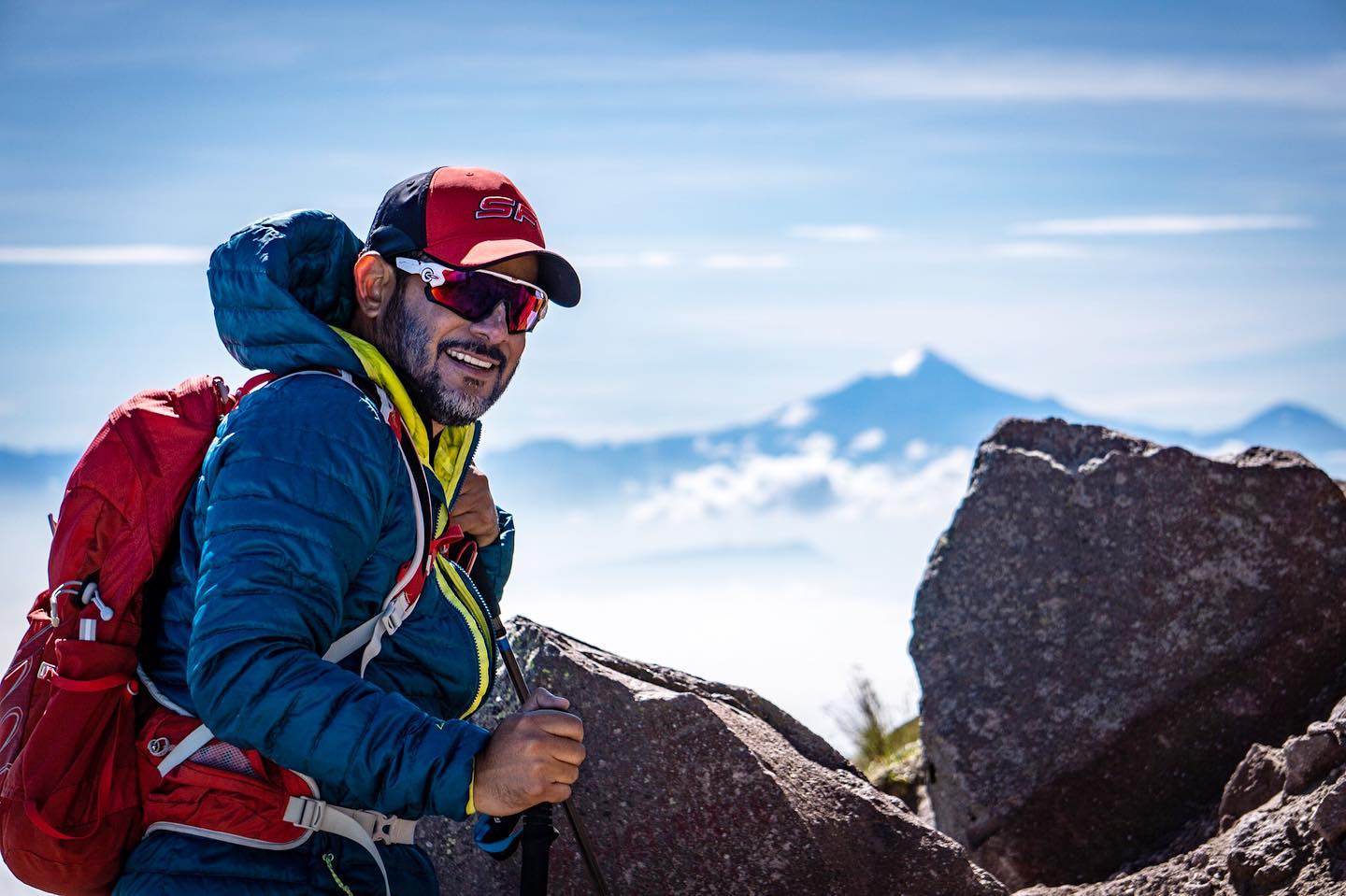 Smiling climber on La Malinche volcano with Pico de Orizaba in the background