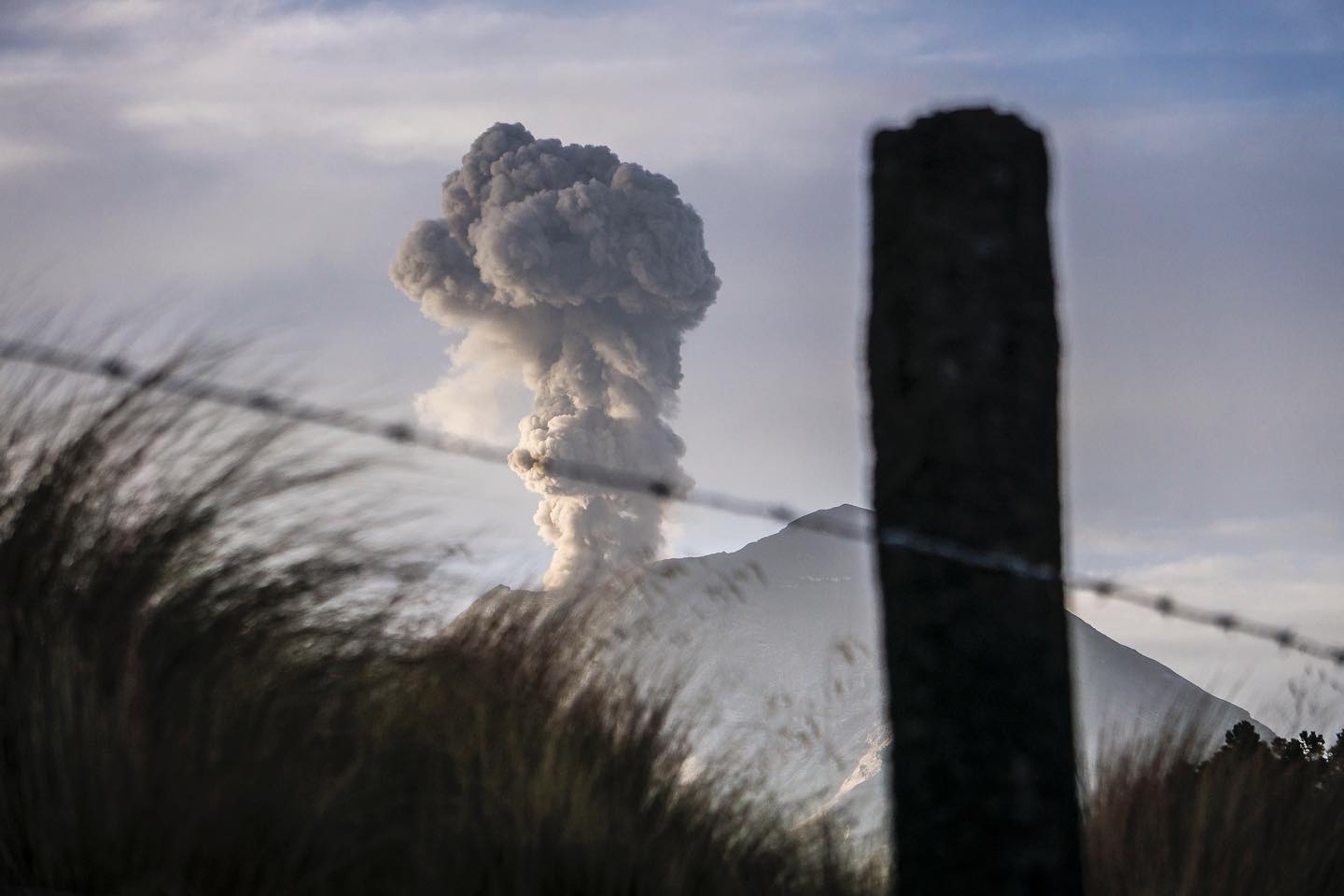 Popocatépetl erupting — an ash column rising above the snowline